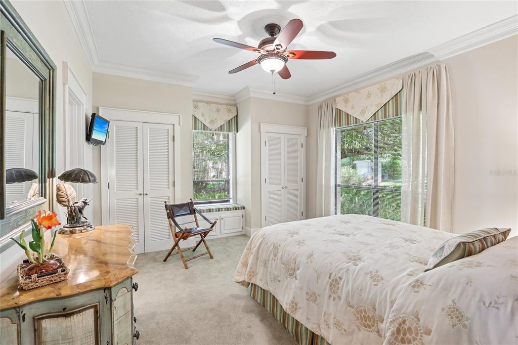 17810 Crawley Road Odessa, FL 33556 - Photo 25 of 76 a bedroom with a bed and a chandelier