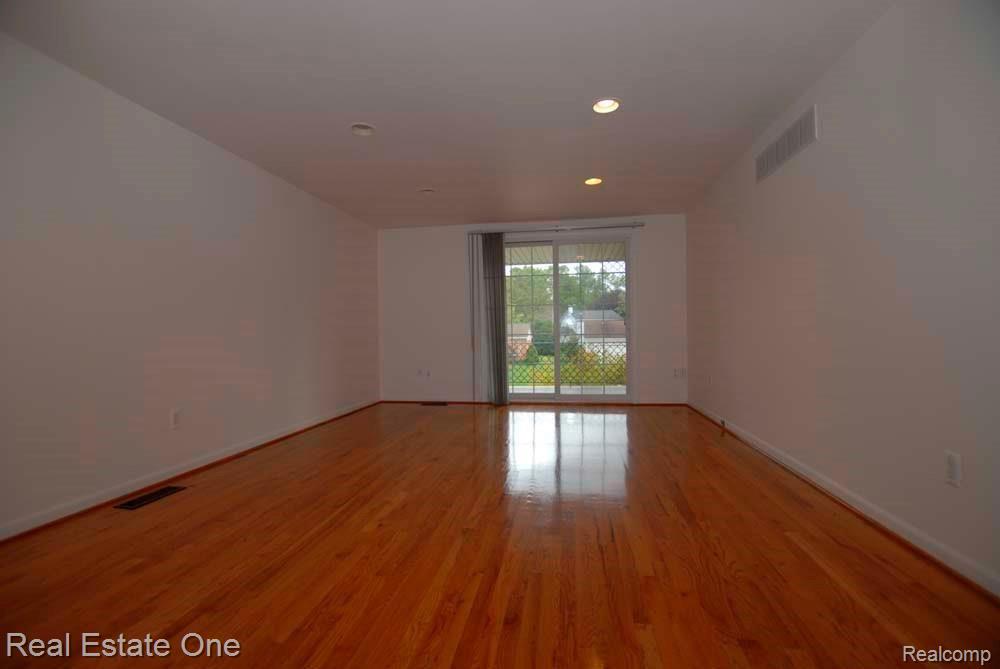 33926 Old Timber Road Farmington, MI 48331 - Photo 10 of 24 Master bedroom with wood floor, patio door access to balcony.