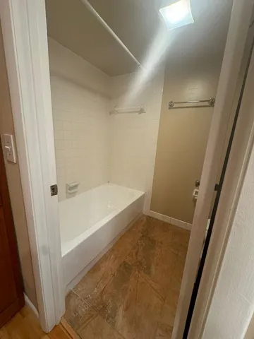 a bathroom with a bathtub and shower