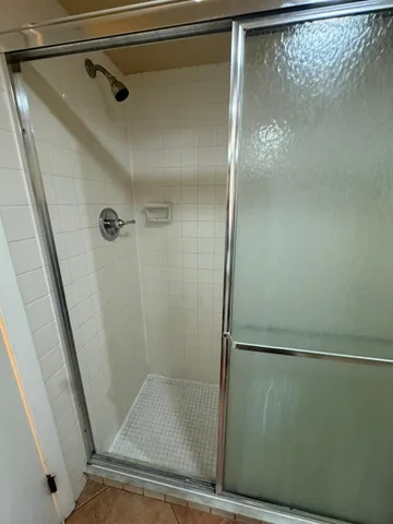 a bathroom with a glass shower door