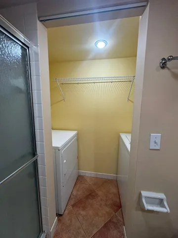 a bathroom with a granite countertop shower and a sink
