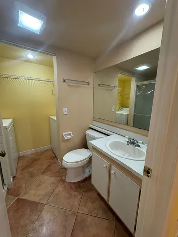 a bathroom with a sink a toilet and a mirror