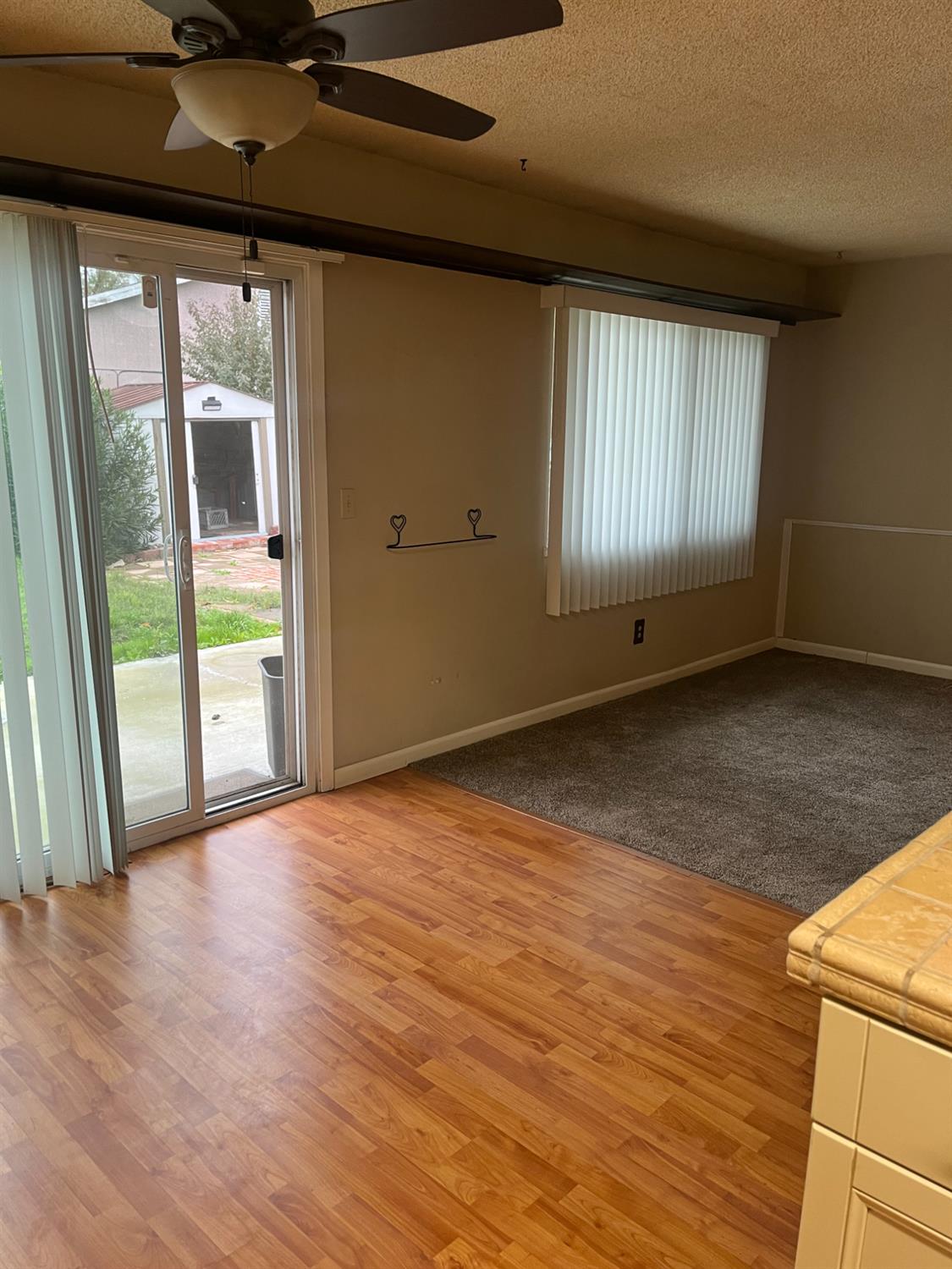 2401 Claridge Lane Stockton, CA 95210 - Photo 5 of 25 a view of an empty room with a window and wooden floor