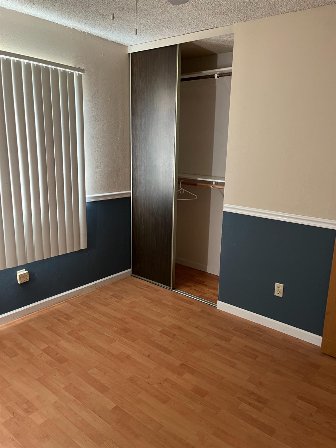 2401 Claridge Lane Stockton, CA 95210 - Photo 9 of 25 a view of an empty room with wooden floor and a window