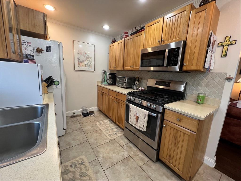 131 Twin Bridges Road Southwest Eatonton, GA 31024 - Photo 23 of 53 a kitchen with stainless steel appliances granite countertop a refrigerator stove and microwave