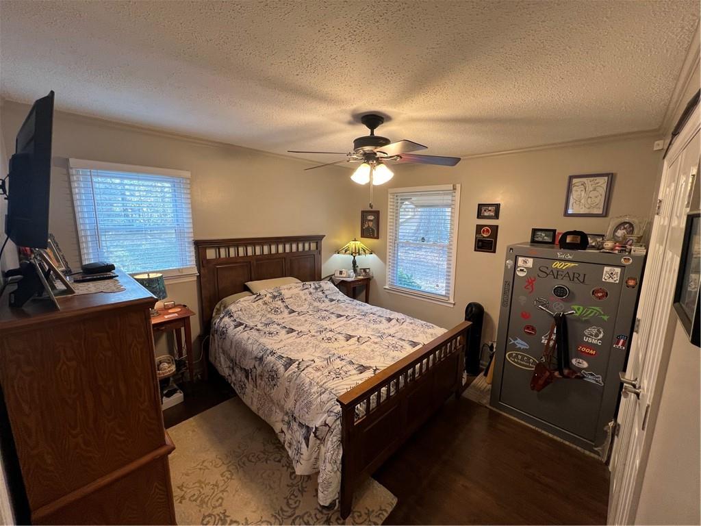 131 Twin Bridges Road Southwest Eatonton, GA 31024 - Photo 25 of 53 a spacious bedroom with a bed and a chandelier