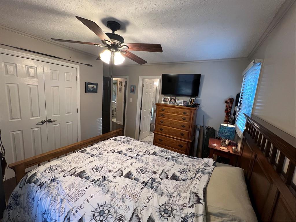 131 Twin Bridges Road Southwest Eatonton, GA 31024 - Photo 27 of 53 a bedroom with a bed and a flat screen tv