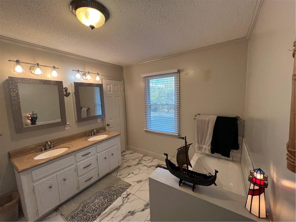 131 Twin Bridges Road Southwest Eatonton, GA 31024 - Photo 28 of 53 a bathroom with a double vanity sink and a mirror