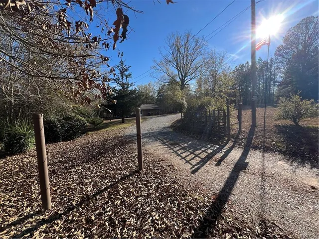 a view of a backyard with wooden fence