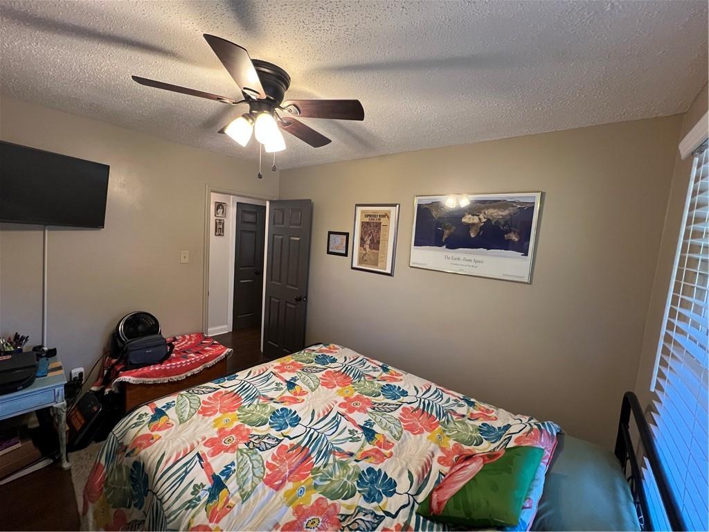 131 Twin Bridges Road Southwest Eatonton, GA 31024 - Photo 32 of 53 a bedroom with a bed and a chandelier