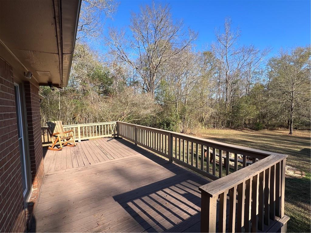131 Twin Bridges Road Southwest Eatonton, GA 31024 - Photo 41 of 53 a balcony with wooden floor and trees in the back
