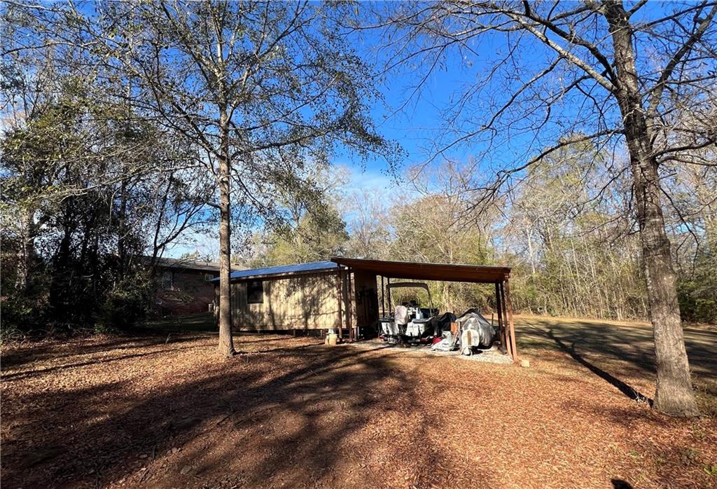 131 Twin Bridges Road Southwest Eatonton, GA 31024 - Photo 53 of 53 a view of a house with large space and a car parked beside it