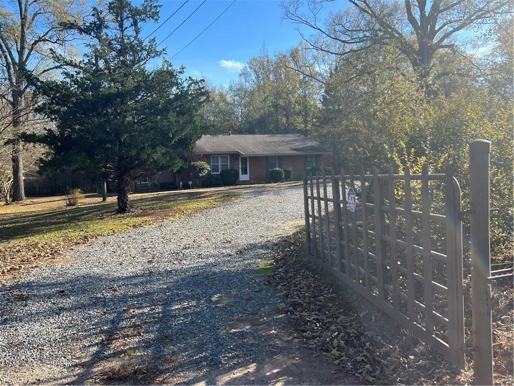 131 Twin Bridges Road Southwest Eatonton, GA 31024 - Photo 6 of 53 a view of a house with backyard and trees