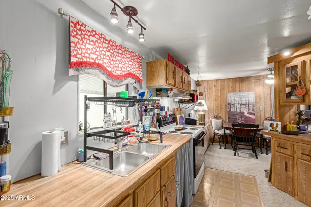 a kitchen with stainless steel appliances kitchen island granite countertop a sink and cabinets