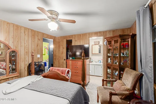 a bedroom with a bed window and flat screen tv