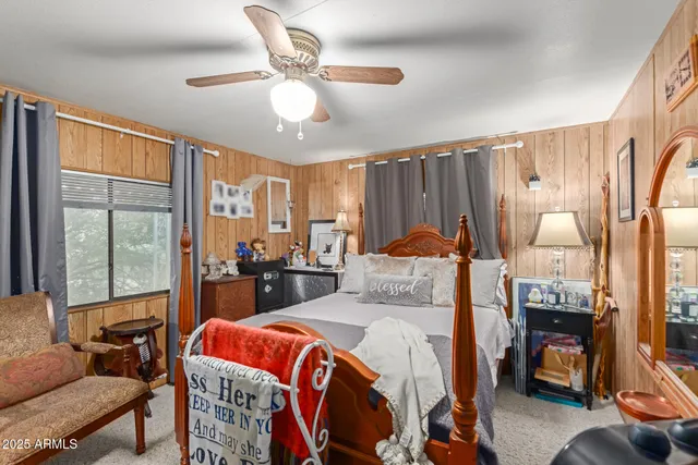 a bedroom with a bed a couch and dresser