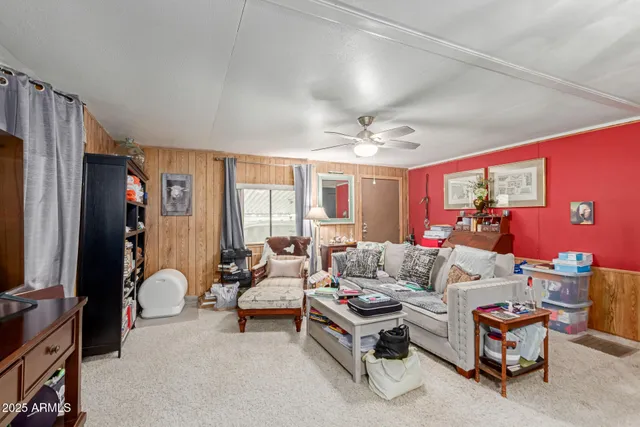 a living room with furniture ceiling fan and a flat screen tv