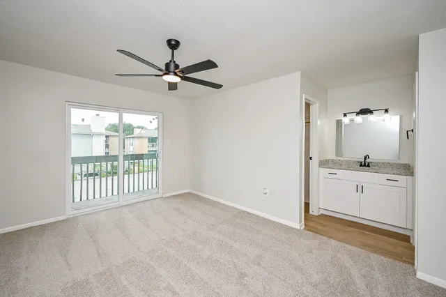 a very nice looking room with a ceiling fan and a window