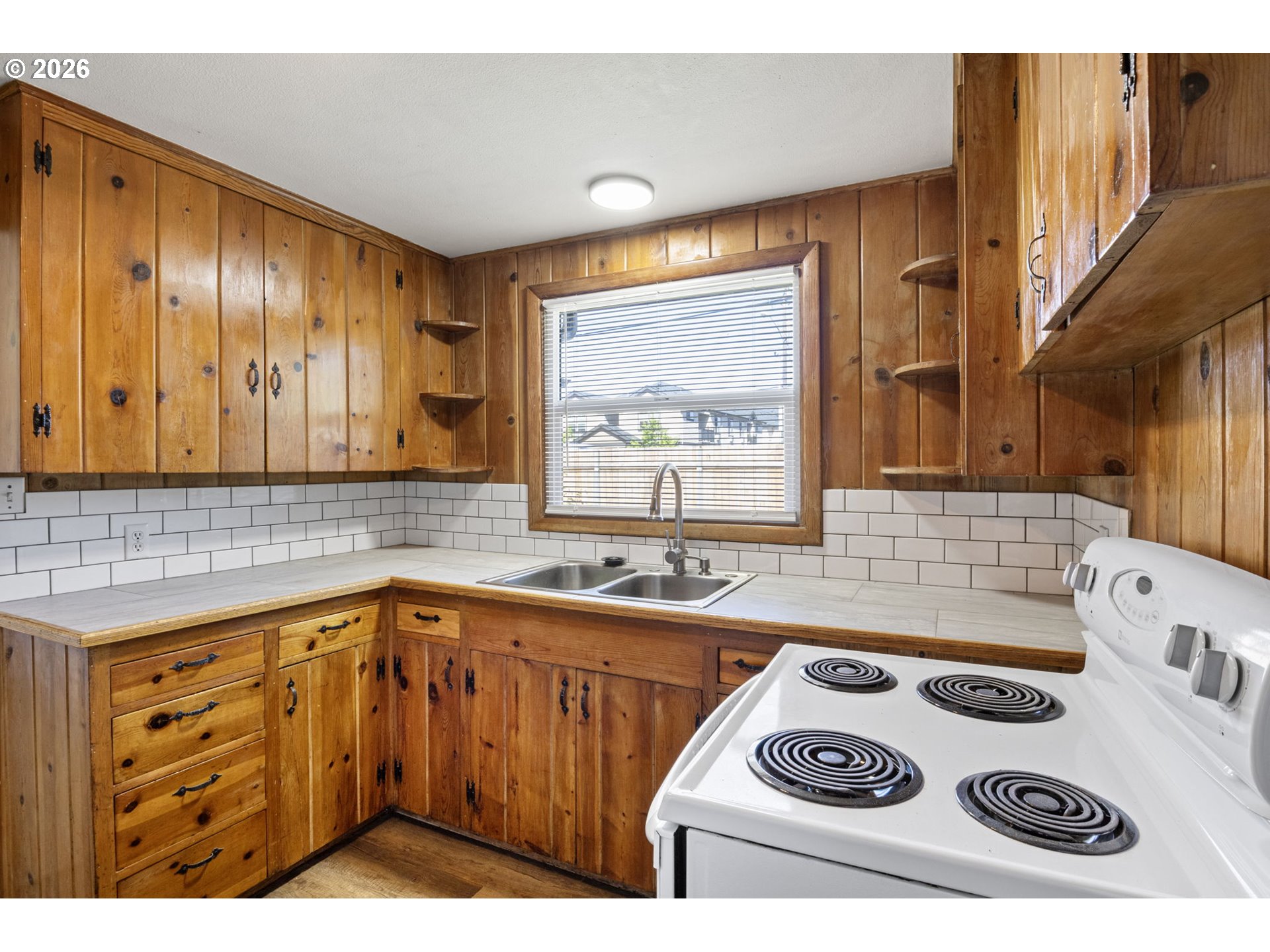 1008 Coburg Road Eugene, OR 97401 - Photo 11 of 46 a kitchen with a sink a stove and a microwave