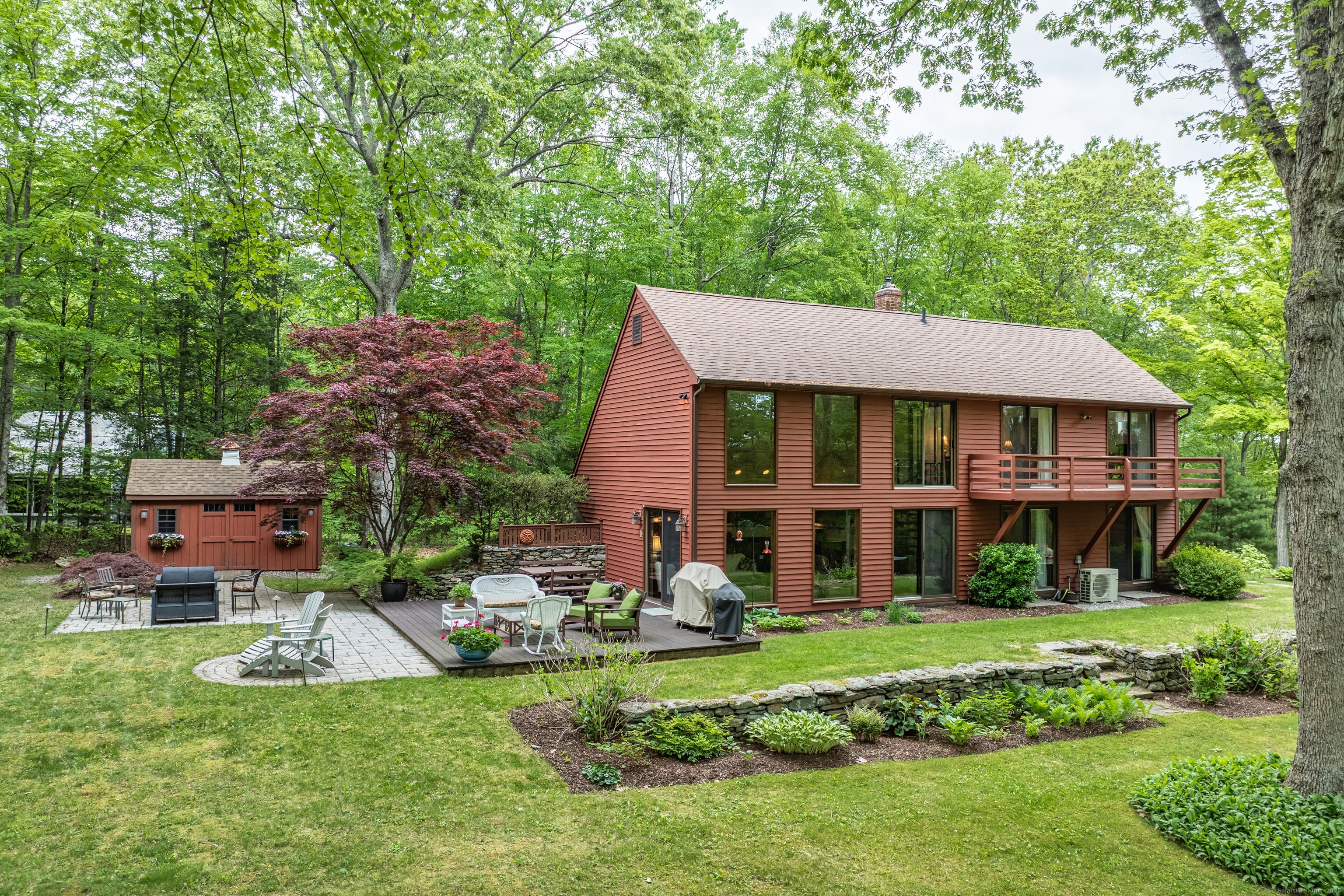 a view of a house with a yard and sitting area