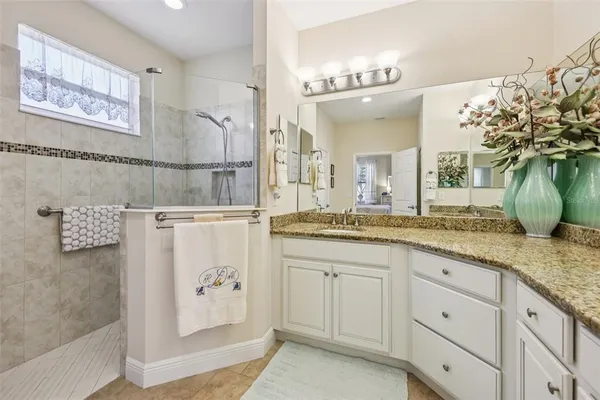 a bedroom with bed couch and window