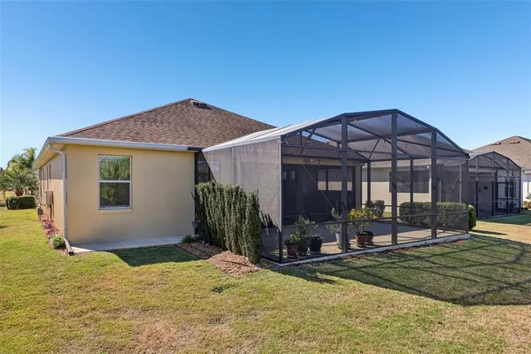 a backyard of a house with barbeque oven table and chairs