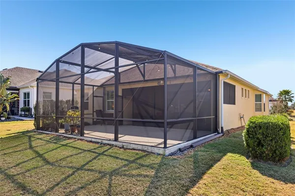 a view of a bedroom with furniture and paintings on the wall