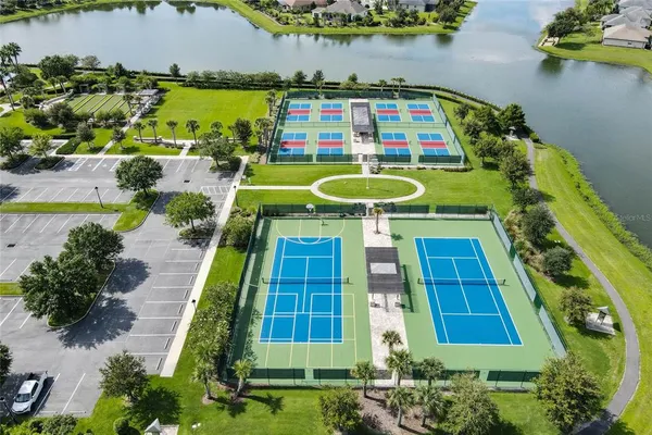 an aerial view of a houses with a lake
