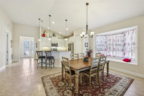 a dining room filled with lots of furniture and appliances