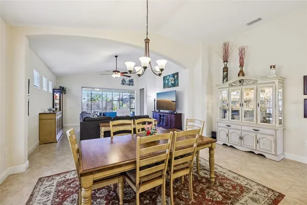 a view of a dining room with furniture and chandelier