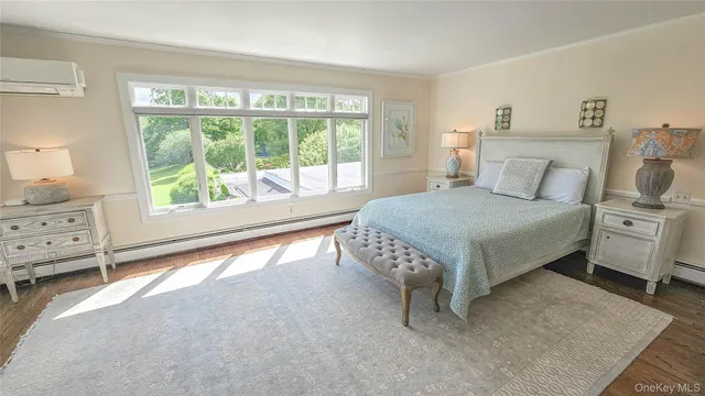 a bedroom with a bed and large window