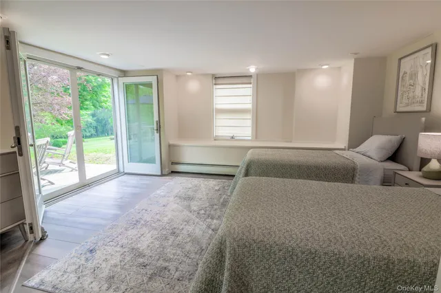 a spacious bedroom with a large bed and a large window