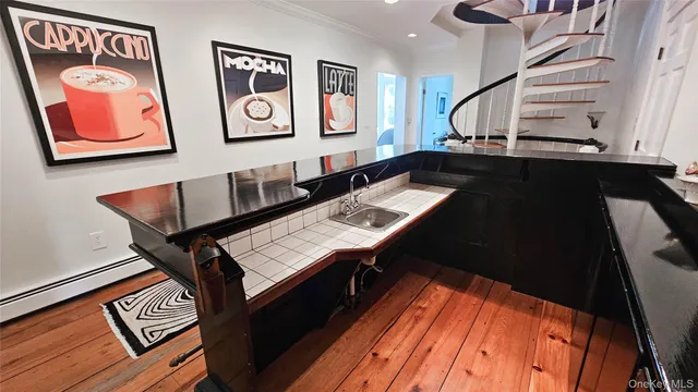 a view of a room with shelves and wooden floor