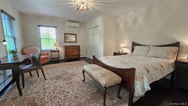 a spacious bedroom with a bed and a chandelier