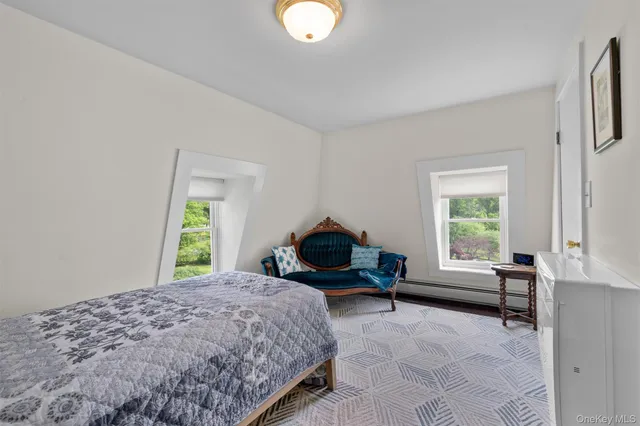 a spacious bedroom with a bed and a couch