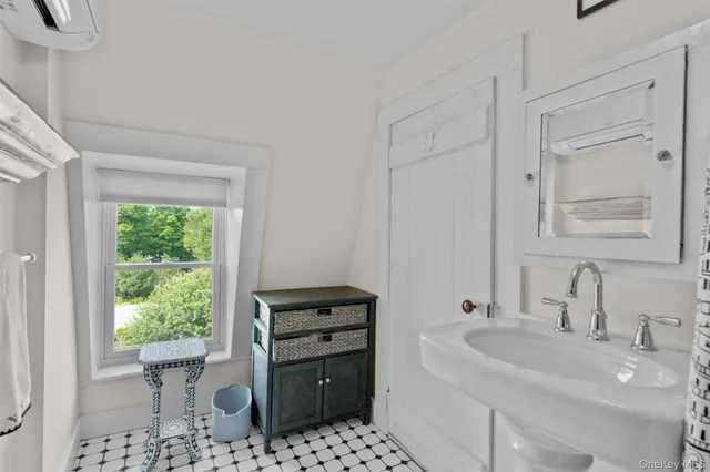 a bathroom with a sink toilet and a window
