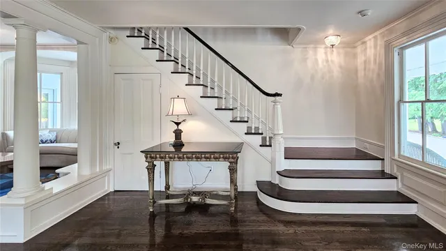 a view of entryway and hall with wooden floor