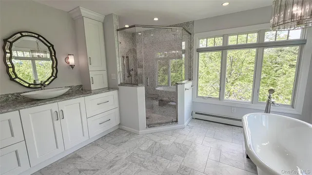 a spacious bathroom with a bathtub and a large mirror