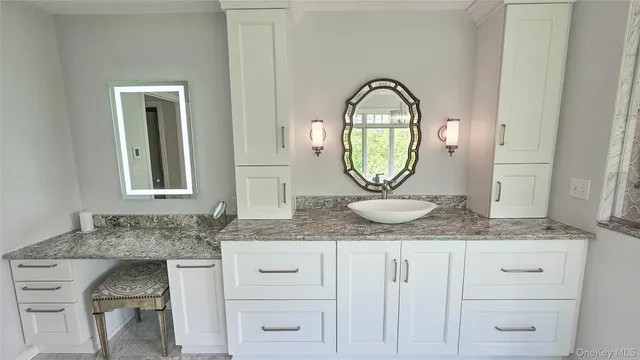 a view of granite countertop white cabinets and a sink