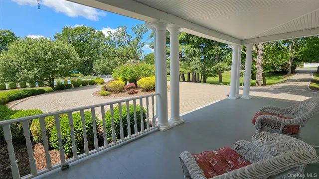 a view of a porch with furniture and garden