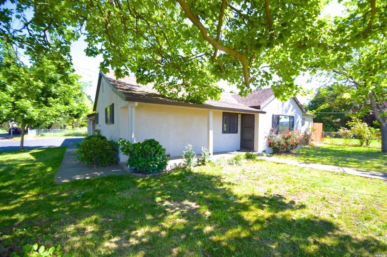 5047 Occidental Road Santa Rosa, CA 95401 - Photo 1 of 1 a backyard of a house with yard and outdoor seating