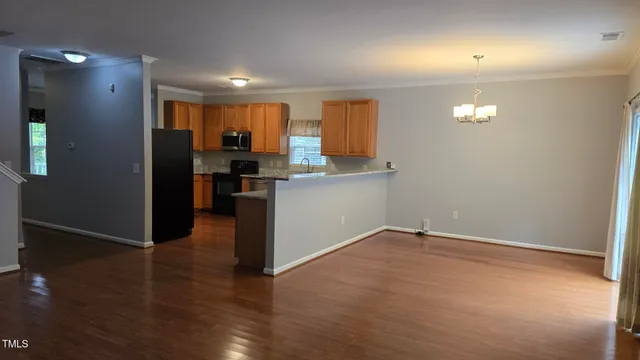 a view of a kitchen with a sink and a refrigerator