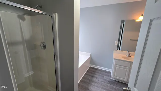 a bathroom with a shower and a sink