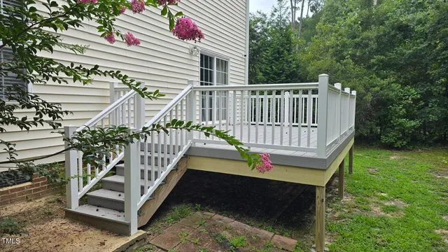 a view of a house with a wooden deck