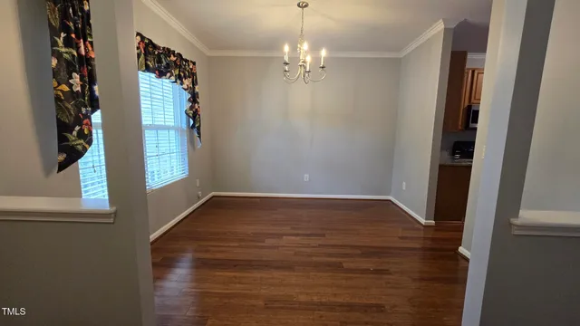 a view of a room with window and hardwood floor
