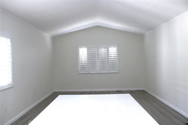 a workspace with wooden floor and windows