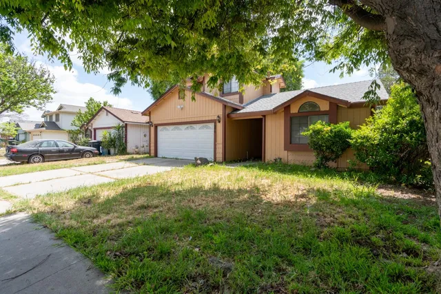 a house that has a tree in front of it