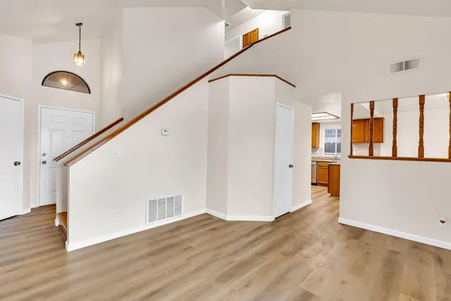 a view of an entryway with wooden floor