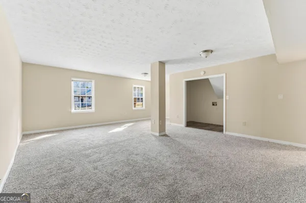 an empty room with windows and closet