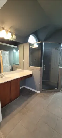 a spacious bathroom with a double vanity sink and a mirror